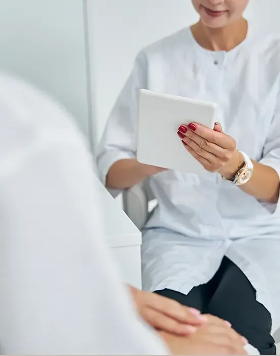 Dermatologist reviewing a patient's chart on a tablet
