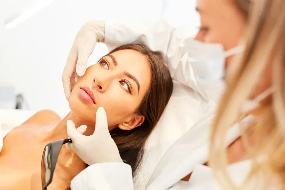 Clinician examining a woman's face
