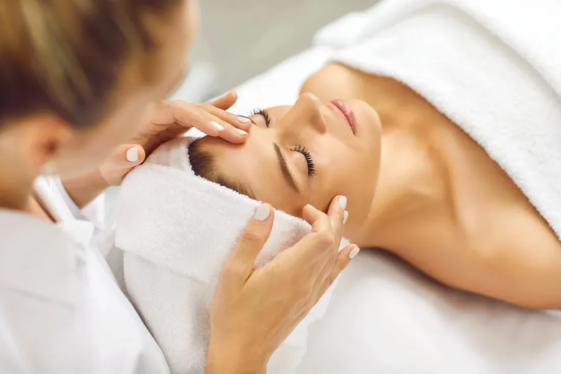Aesthetician massaging a woman's face