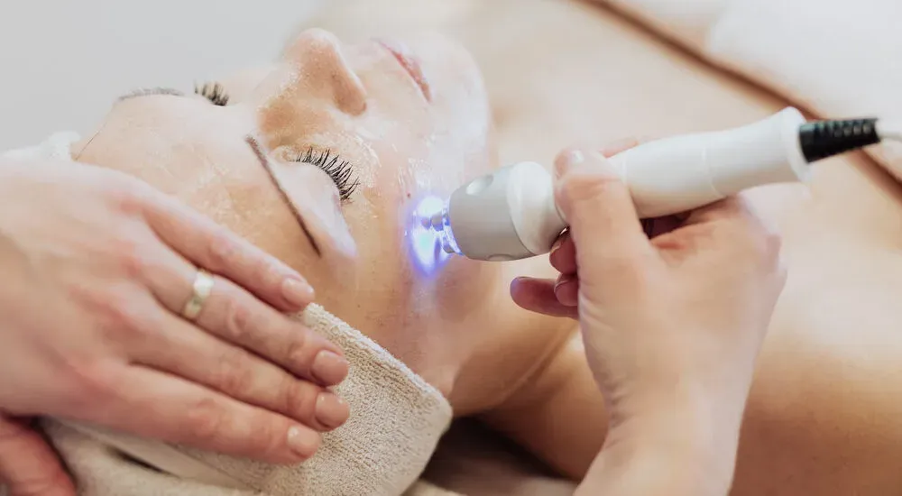 Blue-light device passed over a woman's face
