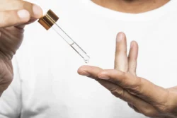 close up hands holding serum pipette - Is Hyaluronic Acid Good for Acne? A Complete Guide