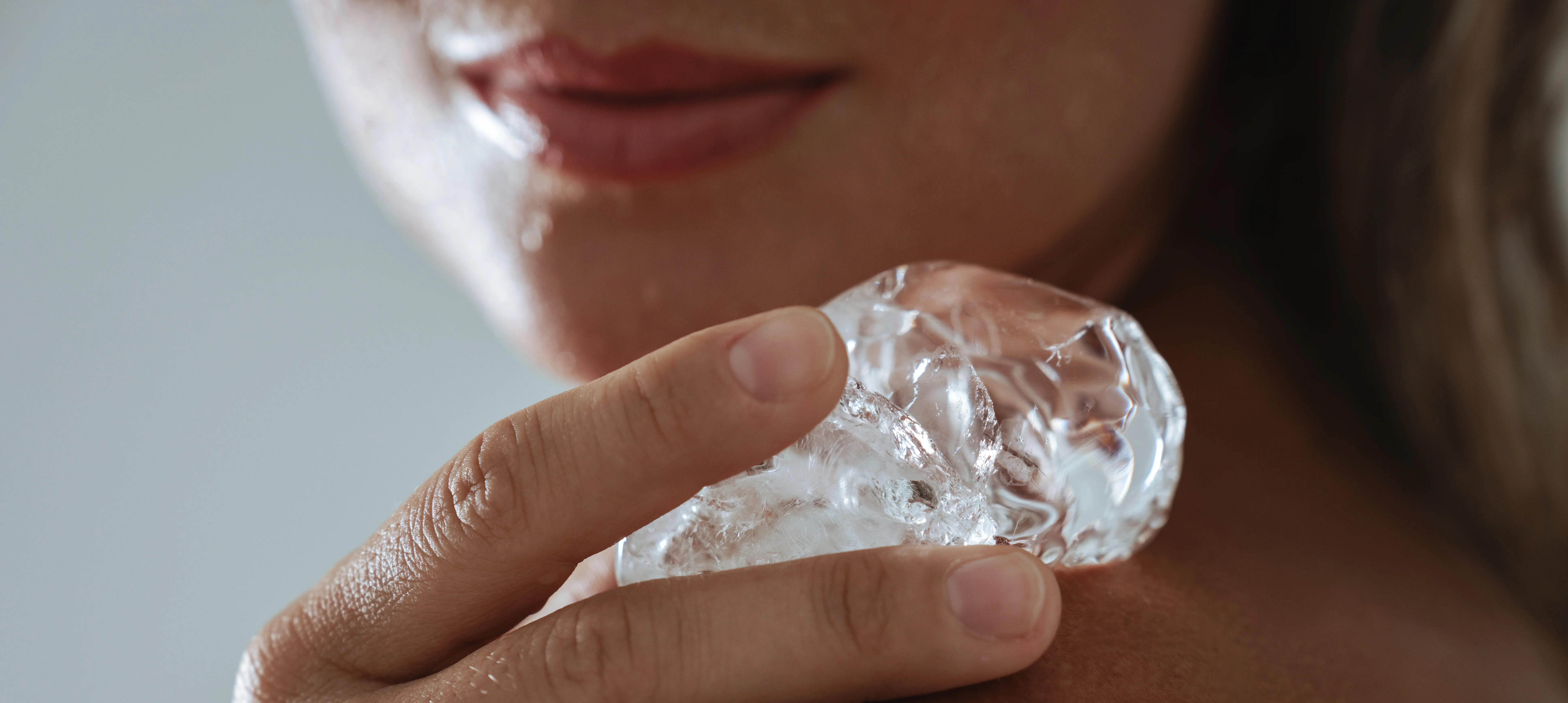 woman cooling skin with ice facial therapy - Does Ice Help Acne or Make It Worse? - Palm Beach Dermatology Group