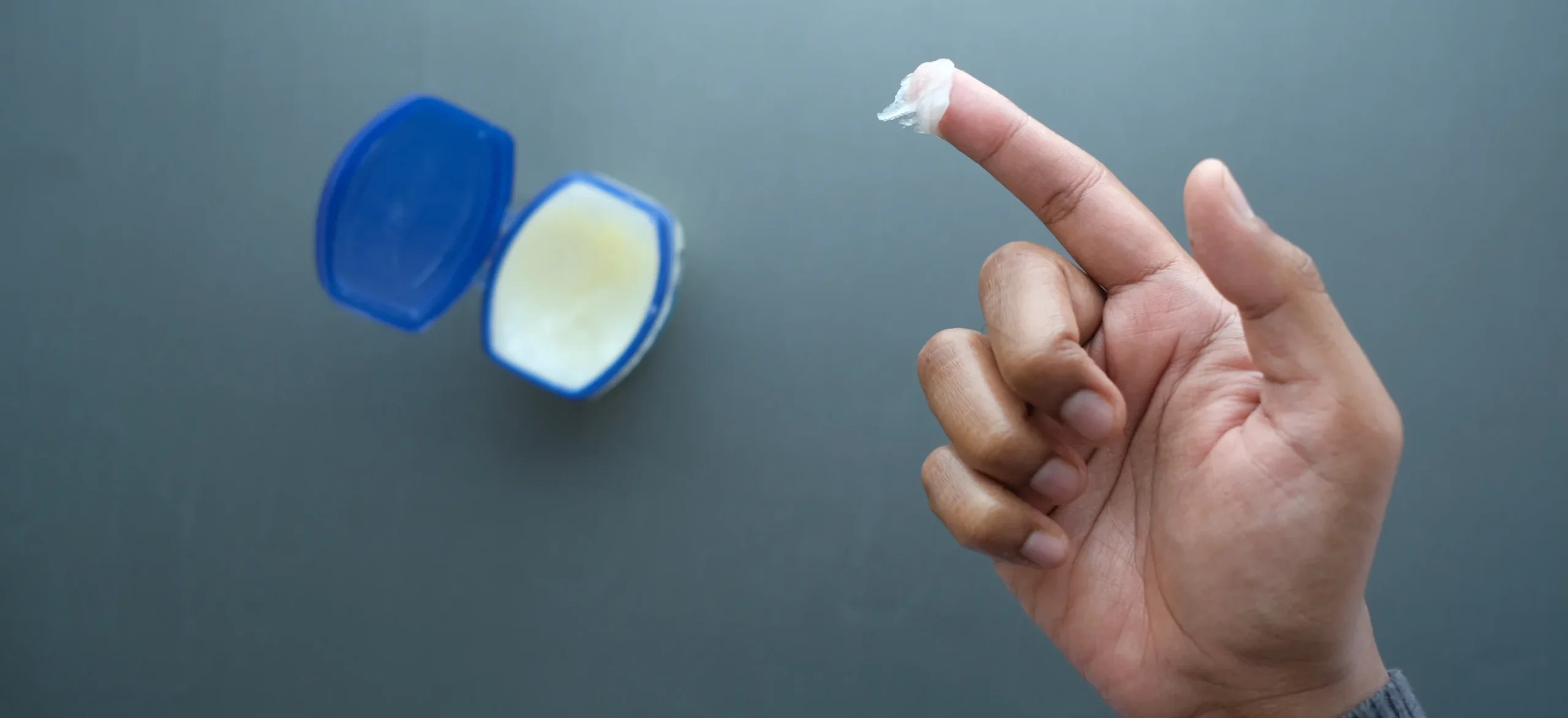 Close up of man hand using petroleum - Is Vaseline Good for Eczema? Benefits, Drawbacks & Best Ways To Use it - Palm Beach Dermatology Group