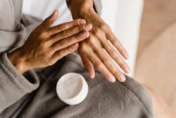 woman applying moisturizing cream on her hands - Is Vaseline Good for Eczema? Benefits, Drawbacks & Best Ways To Use it - Palm Beach Dermatology Group