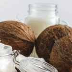 coconuts and jars of coconut butter - Does Coconut Oil Help With Eczema? - Palm Beach Dermatology Group